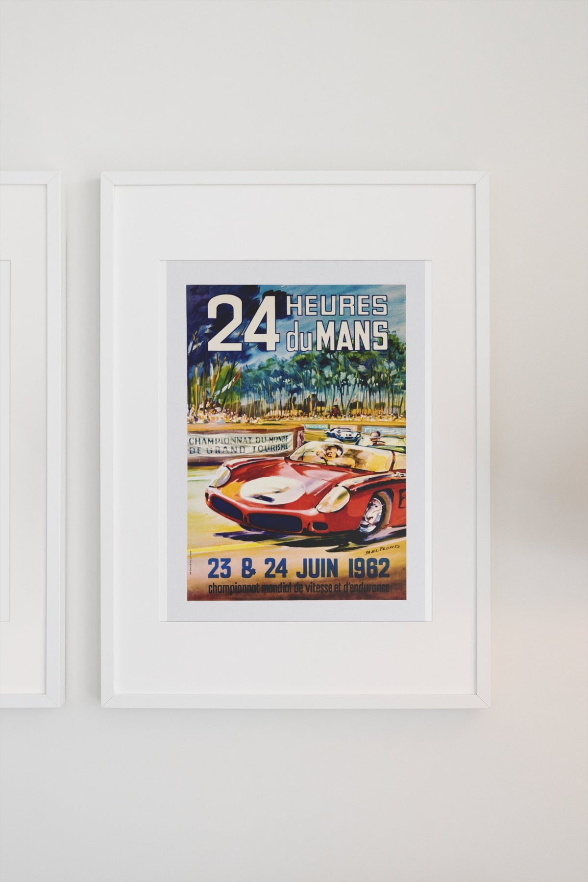 24 Heures du Mans 1962 poster in a white frame on a light wall