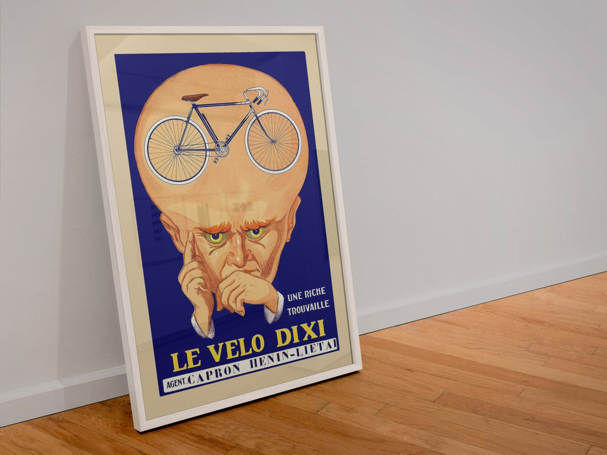 Le Velo Dixi poster in a white frame leaning against a wall