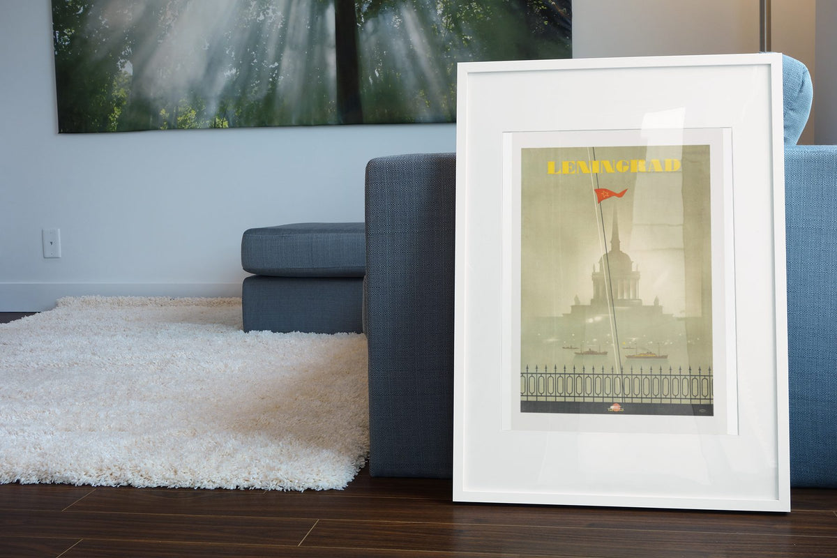 Leningrad St Petersburg poster leaning beside a blue sofa