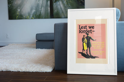 Lest We Forget poster in a white frame leaning beside a blue sofa