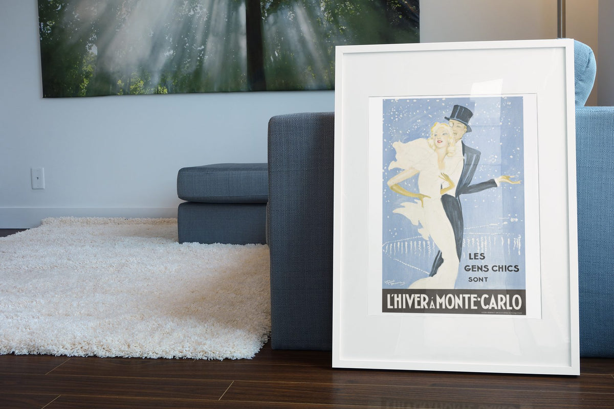 L Hiver a Monte-Carlo poster leaning beside a blue sofa