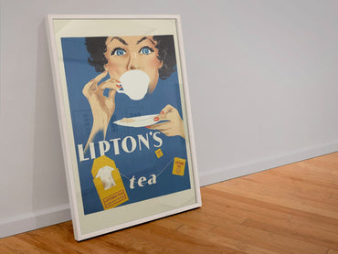 Liptons Tea poster in a white frame leaning against a wall