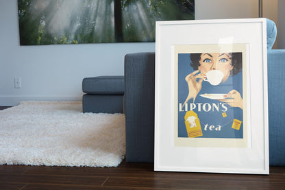 Liptons Tea poster leaning beside a blue sofa