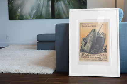 Lloyds Bank Liberation Loan Tank poster leaning beside a blue sofa
