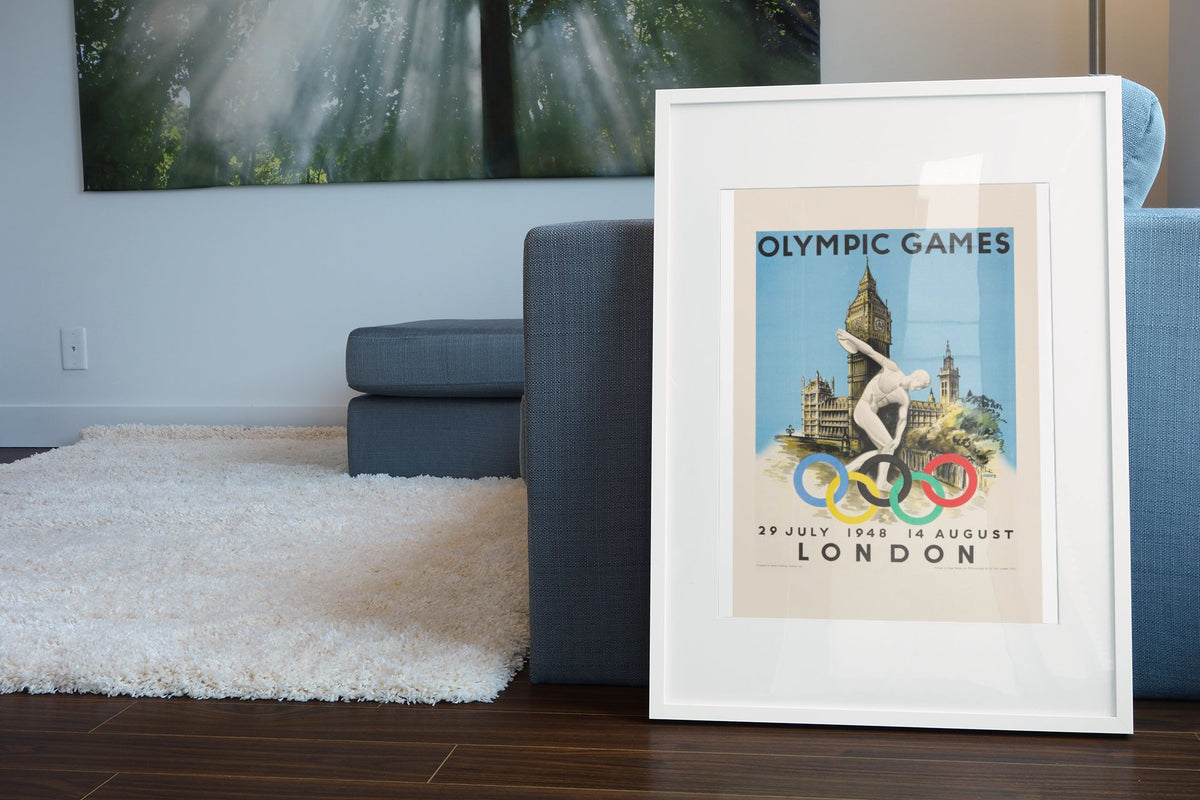 London Olympic Games 1948 poster leaning beside a blue sofa