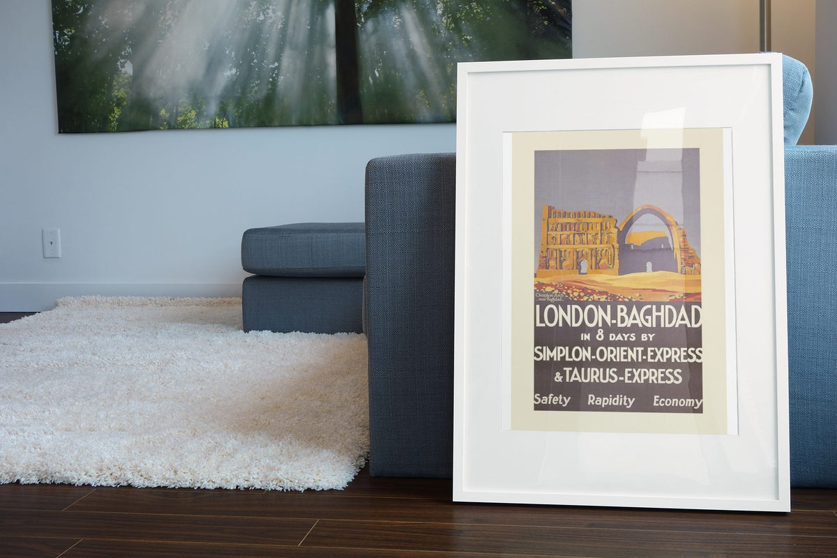 London to Baghdad Orient Express poster leaning beside a blue sofa