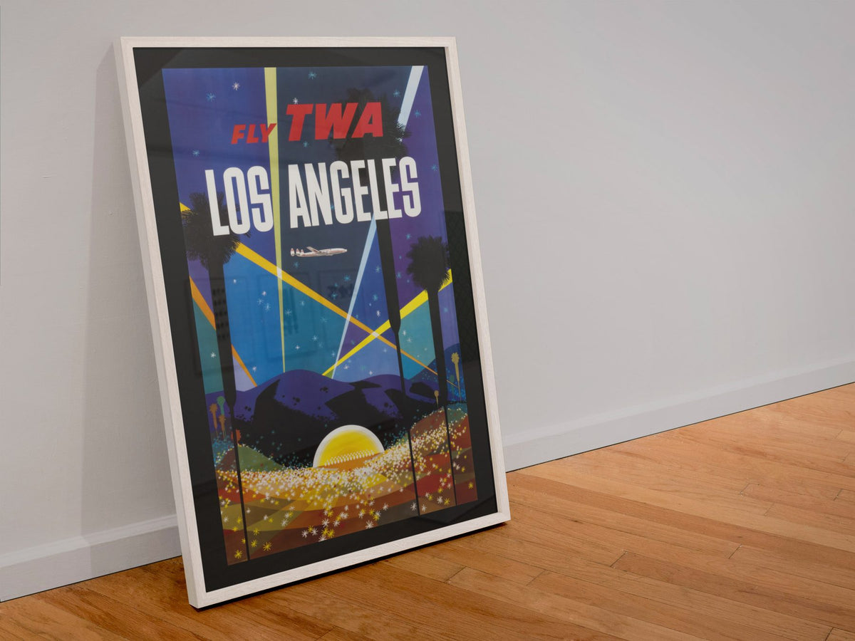 Los Angeles Fly TWA Hollywood poster in a white frame leaning against a wall