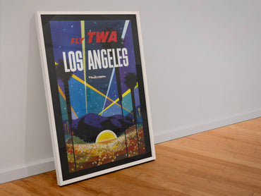 Los Angeles Fly TWA Hollywood poster in a white frame leaning against a wall