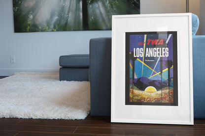 Los Angeles Fly TWA Hollywood poster leaning beside a blue sofa