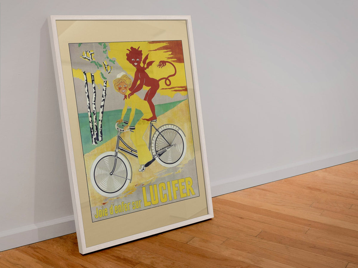 Lucifer Cycles Joie d Enfer poster in a white frame leaning against a wall