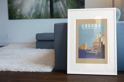 Lugano Southern Switzerland poster leaning beside a blue sofa