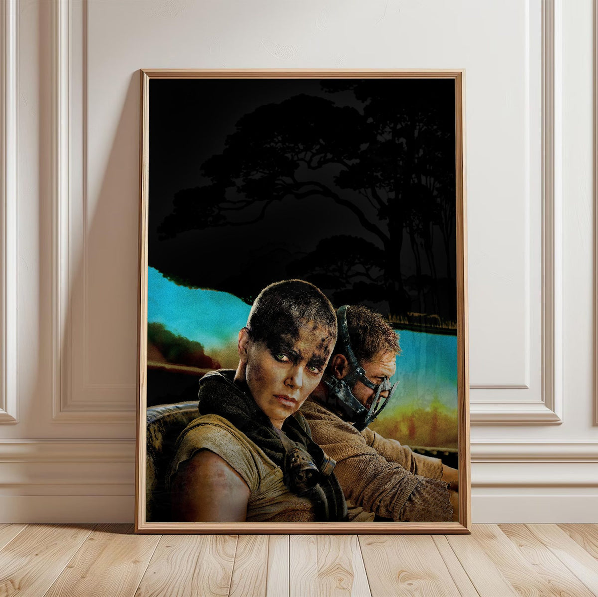 Mad Max: Fury Road (2015) Movie Furiosa and Max Portrait Art poster in a light oak frame leaning against a white wall