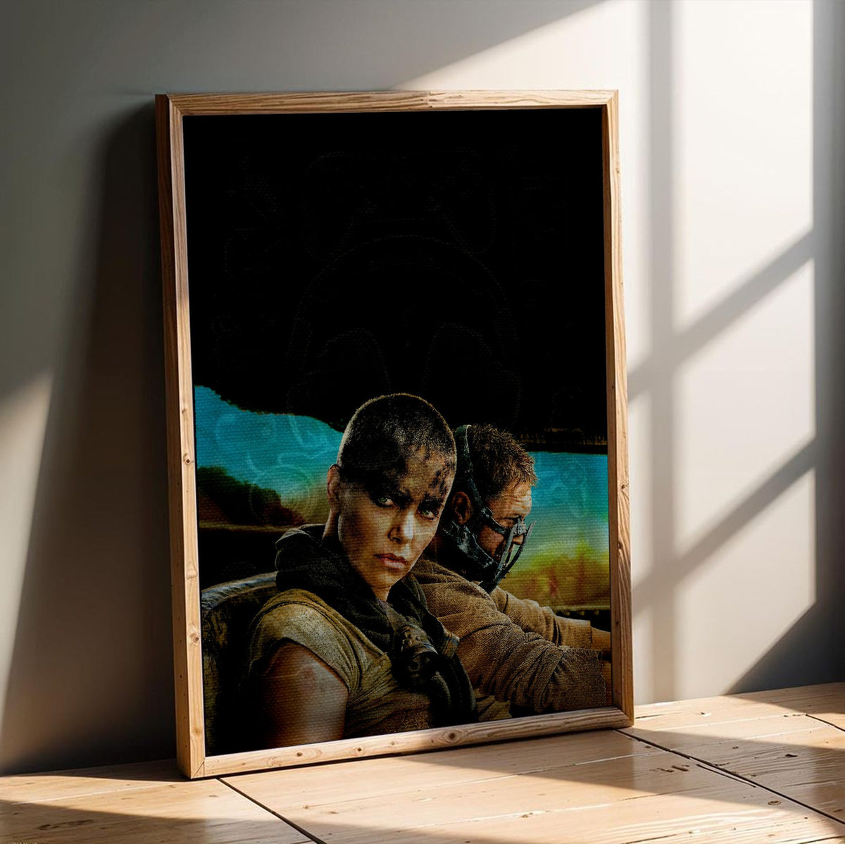 Mad Max: Fury Road (2015) Movie Furiosa and Max Portrait Art poster in an oak frame leaning on a wooden floor