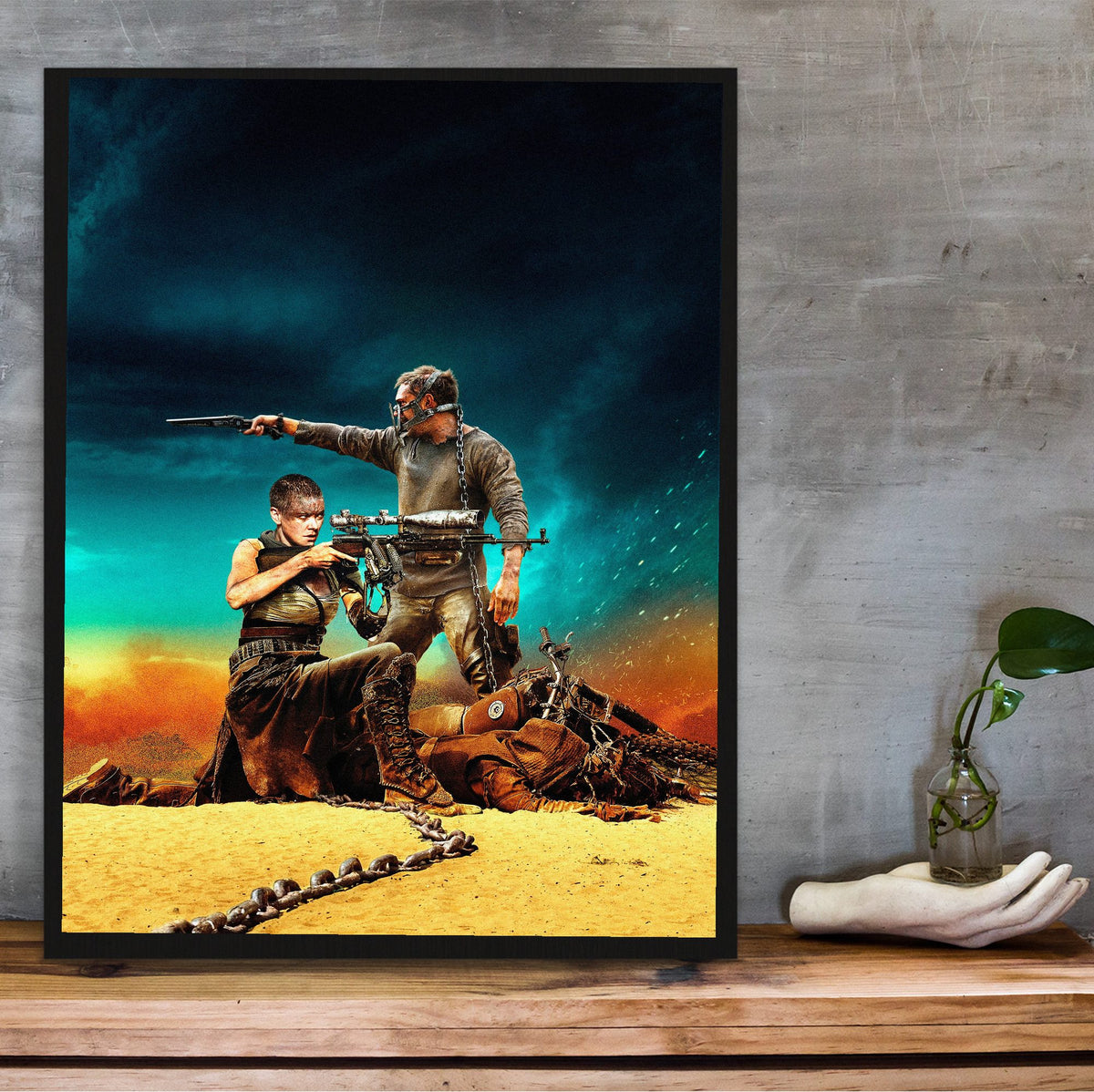 Mad Max: Fury Road (2015) Movie War Rig Art poster in a black frame on a wooden shelf against concrete