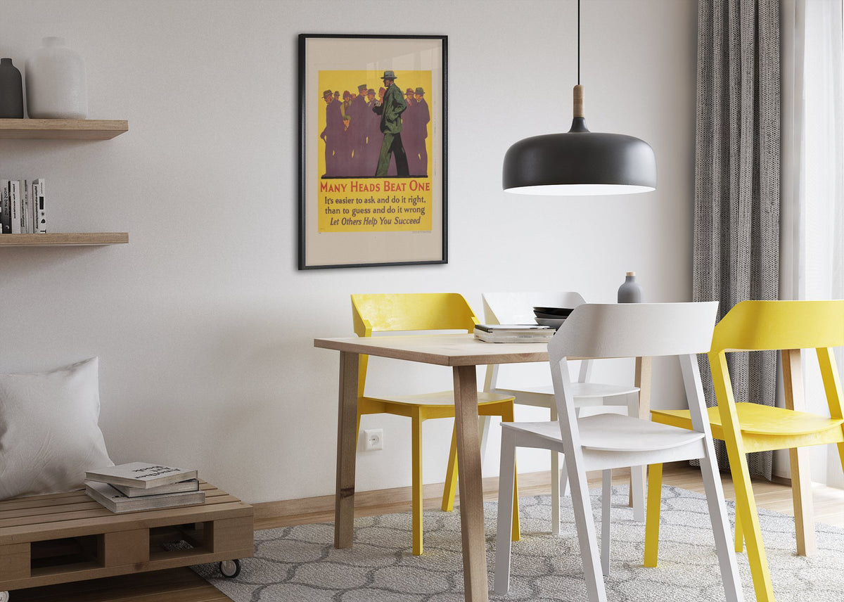 Many Heads Beat One poster framed above a dining table