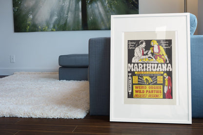 Marihuana Weed With Roots in Hell poster leaning beside a blue sofa