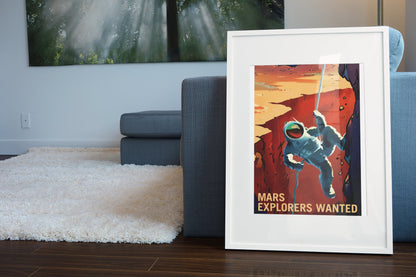 Mars Explorers Wanted poster in a white frame leaning beside a blue sofa