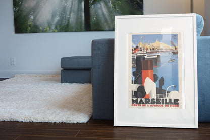Marseille Porte de l Afrique du Nord poster leaning beside a blue sofa