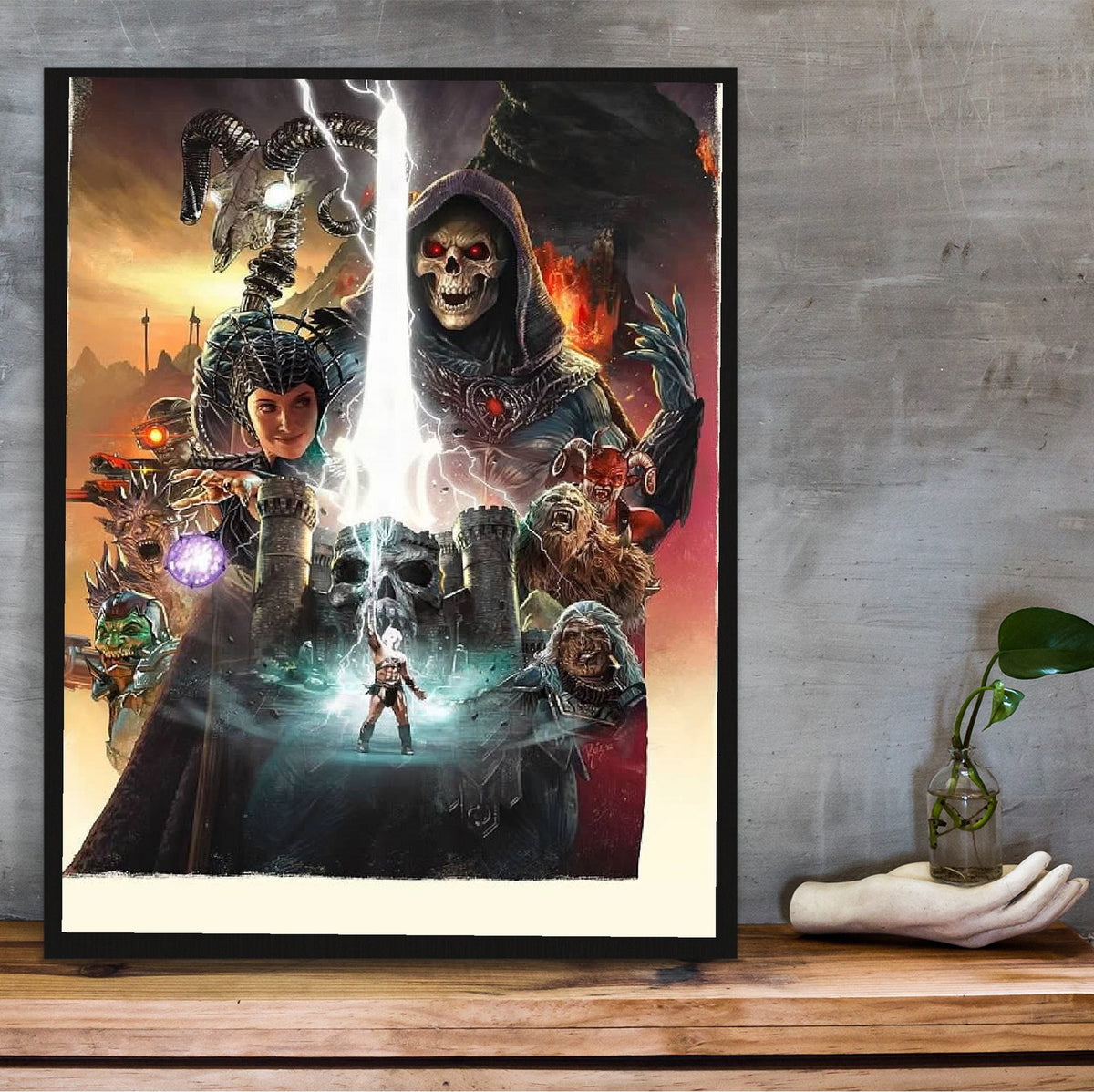 Masters of the Universe (2026) Movie Key Art poster in a black frame on a wooden shelf against concrete