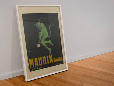 Maurin Quina 1906 green devil by Cappiello poster in a white frame leaning against a wall