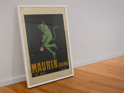 Maurin Quina 1906 green devil by Cappiello poster in a white frame leaning against a wall