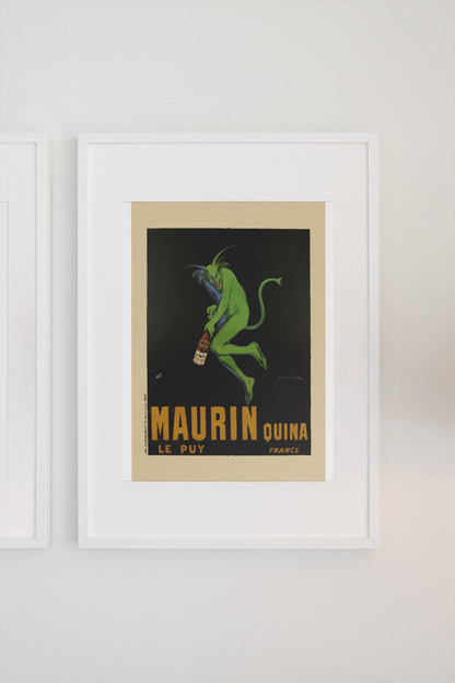 Maurin Quina 1906 green devil by Cappiello poster in a white frame on a light wall