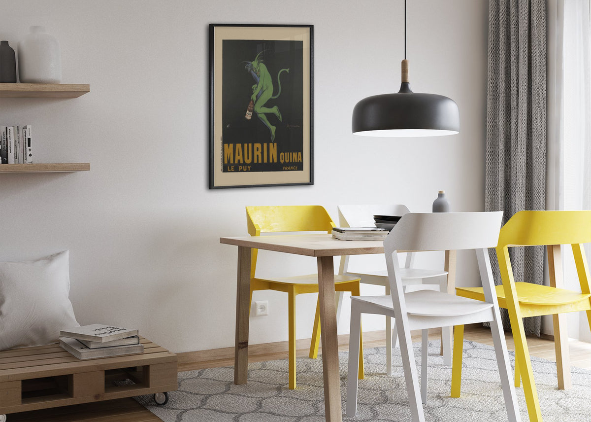 Maurin Quina 1906 green devil by Cappiello poster framed above a dining table