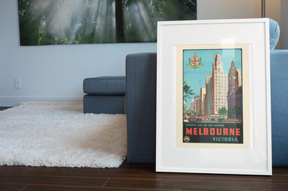 Melbourne Seventh City of the Empire poster leaning beside a blue sofa