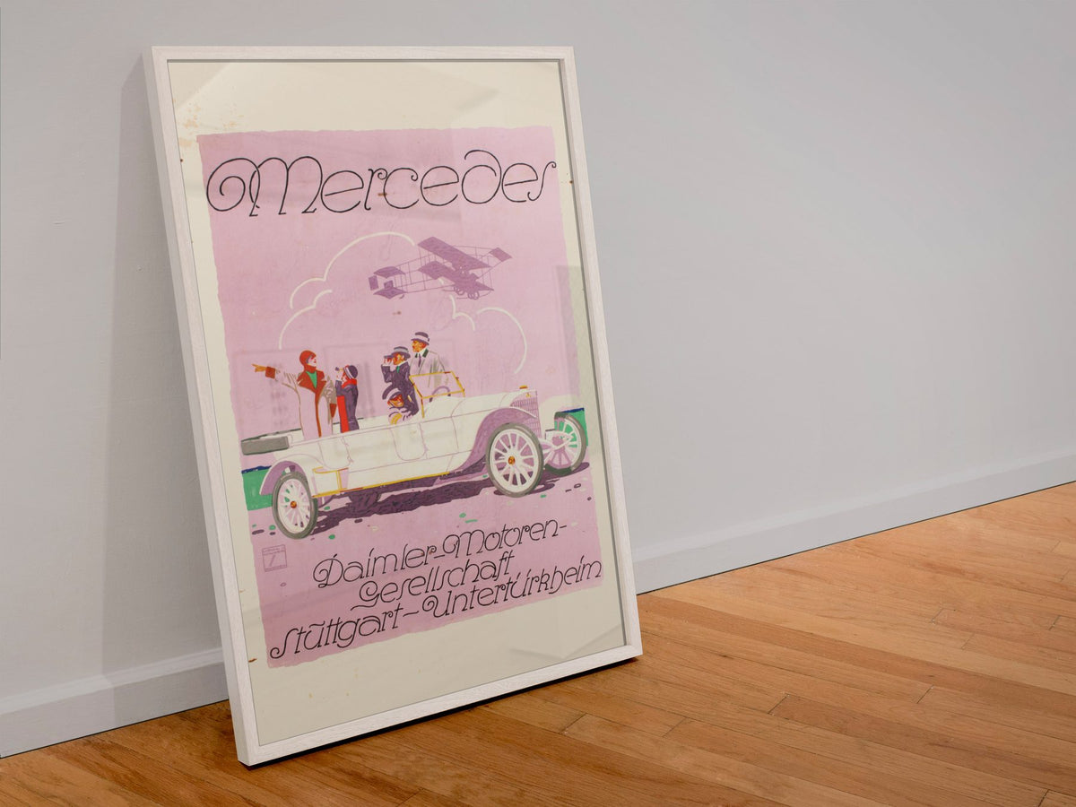 Mercedes Daimler poster in a white frame leaning against a wall
