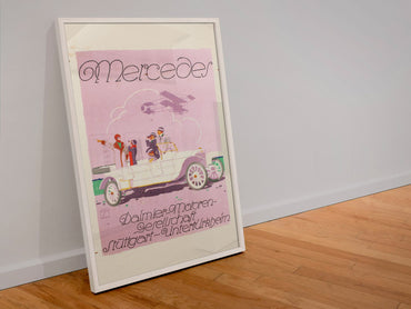 Mercedes Daimler poster in a white frame leaning against a wall