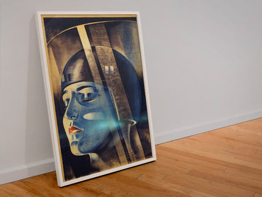 Metropolis poster in a white frame leaning against a wall