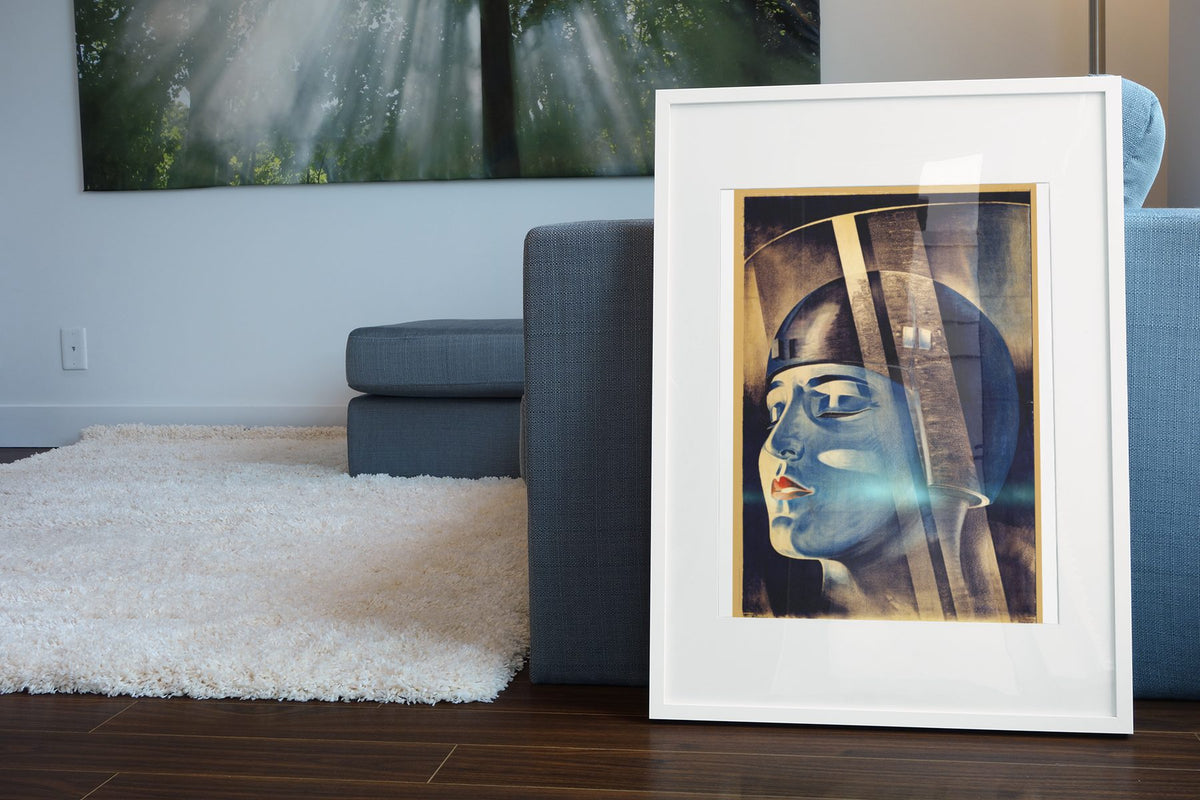 Metropolis poster leaning beside a blue sofa