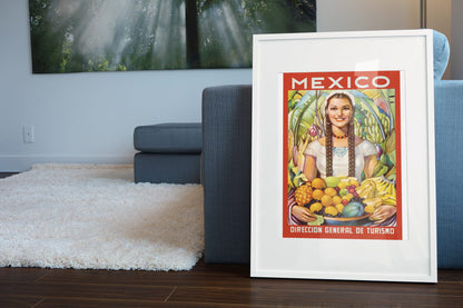 Mexico Girl with Fruit poster leaning beside a blue sofa