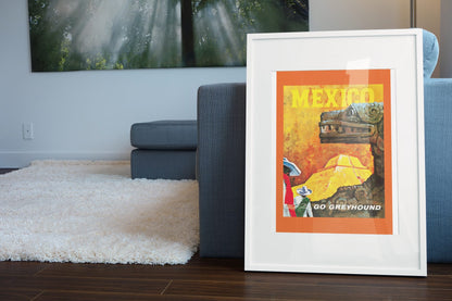Mexico Go Greyhound poster leaning beside a blue sofa