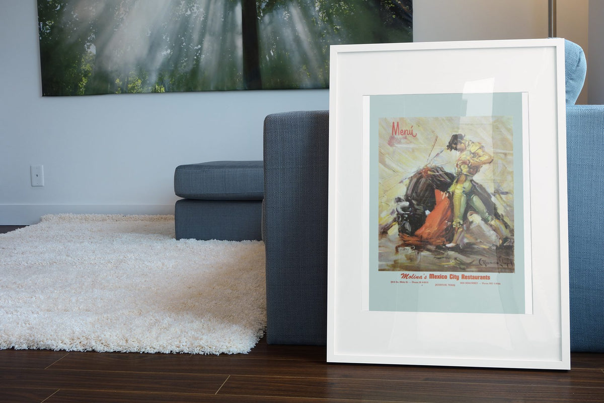 Mexico Bullfighter poster leaning beside a blue sofa