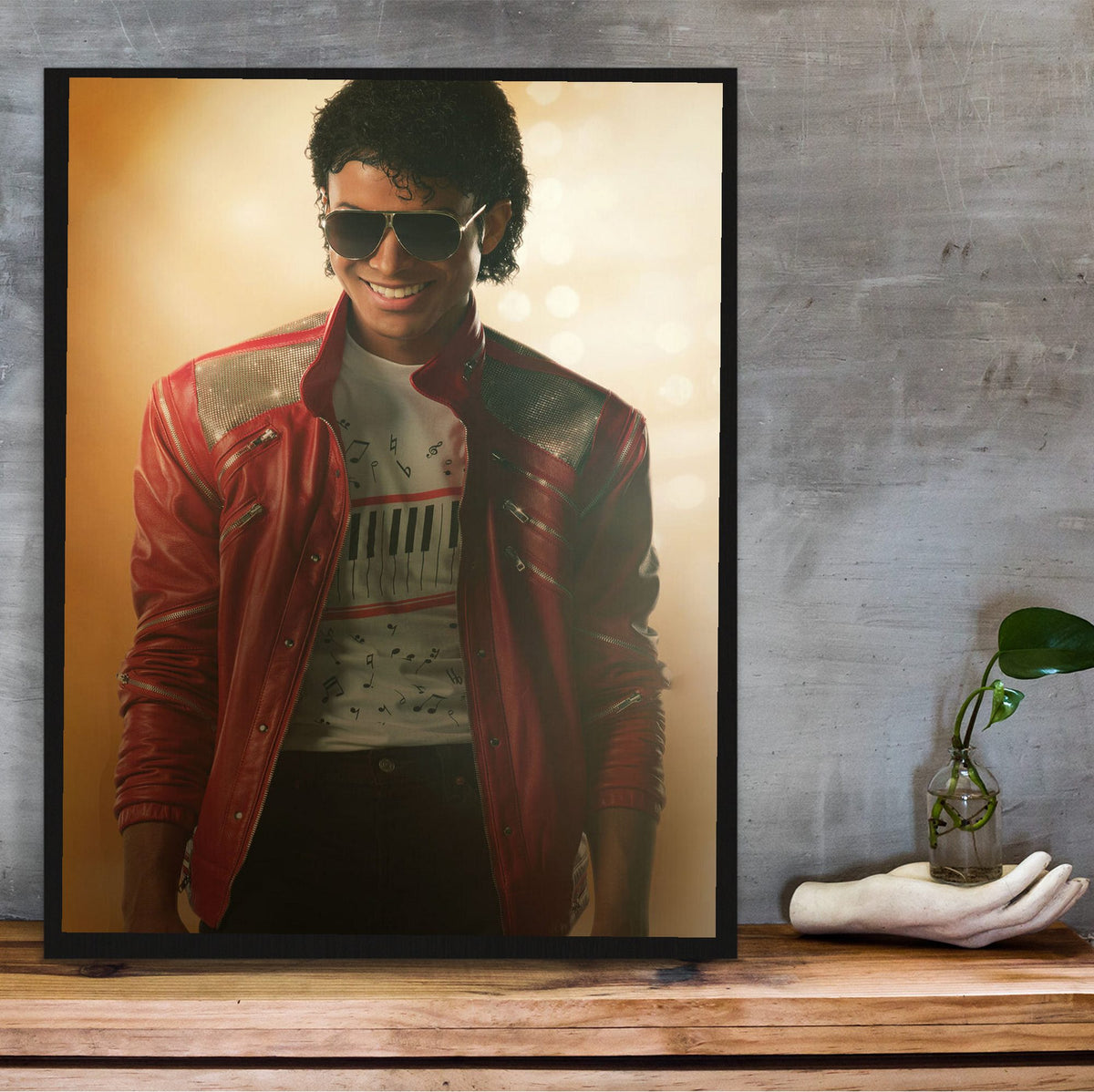 Michael (2026) Movie Key Art poster in a black frame on a wooden shelf against concrete