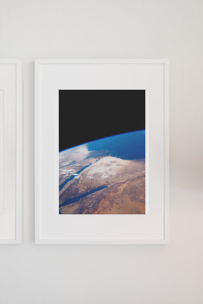 The Middle East seen from space poster in a white frame on a light wall