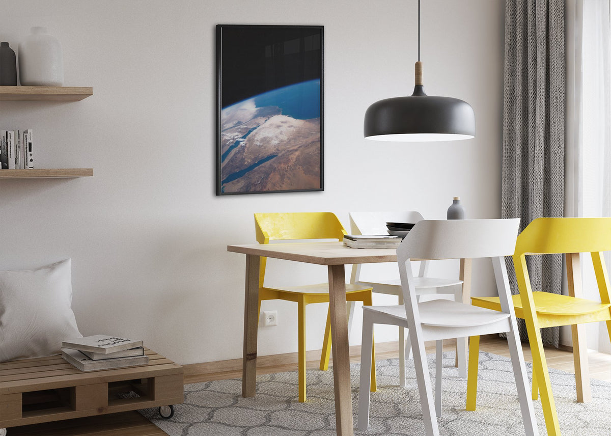 The Middle East seen from space poster framed above a dining table