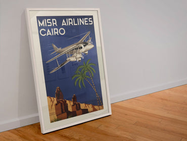Misr Airlines Cairo poster in a white frame leaning against a wall