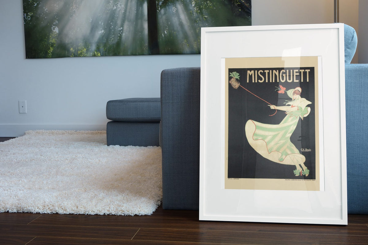 Mistinguett poster leaning beside a blue sofa