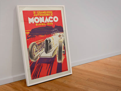 Monaco Grand Prix 1930 poster in a white frame leaning against a wall