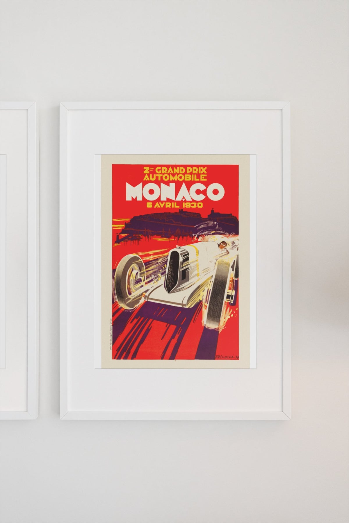 Monaco Grand Prix 1930 poster in a white frame on a light wall