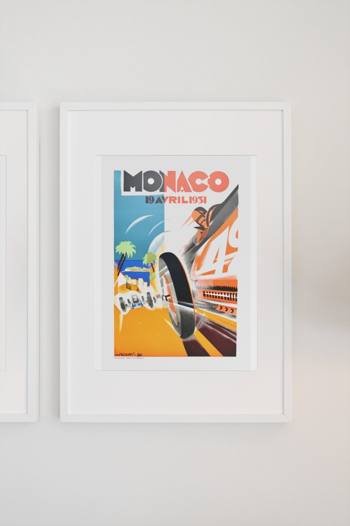 Monaco Grand Prix 1931 poster in a white frame on a light wall