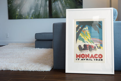 Monaco Grand Prix 1932 poster in a white frame leaning beside a blue sofa