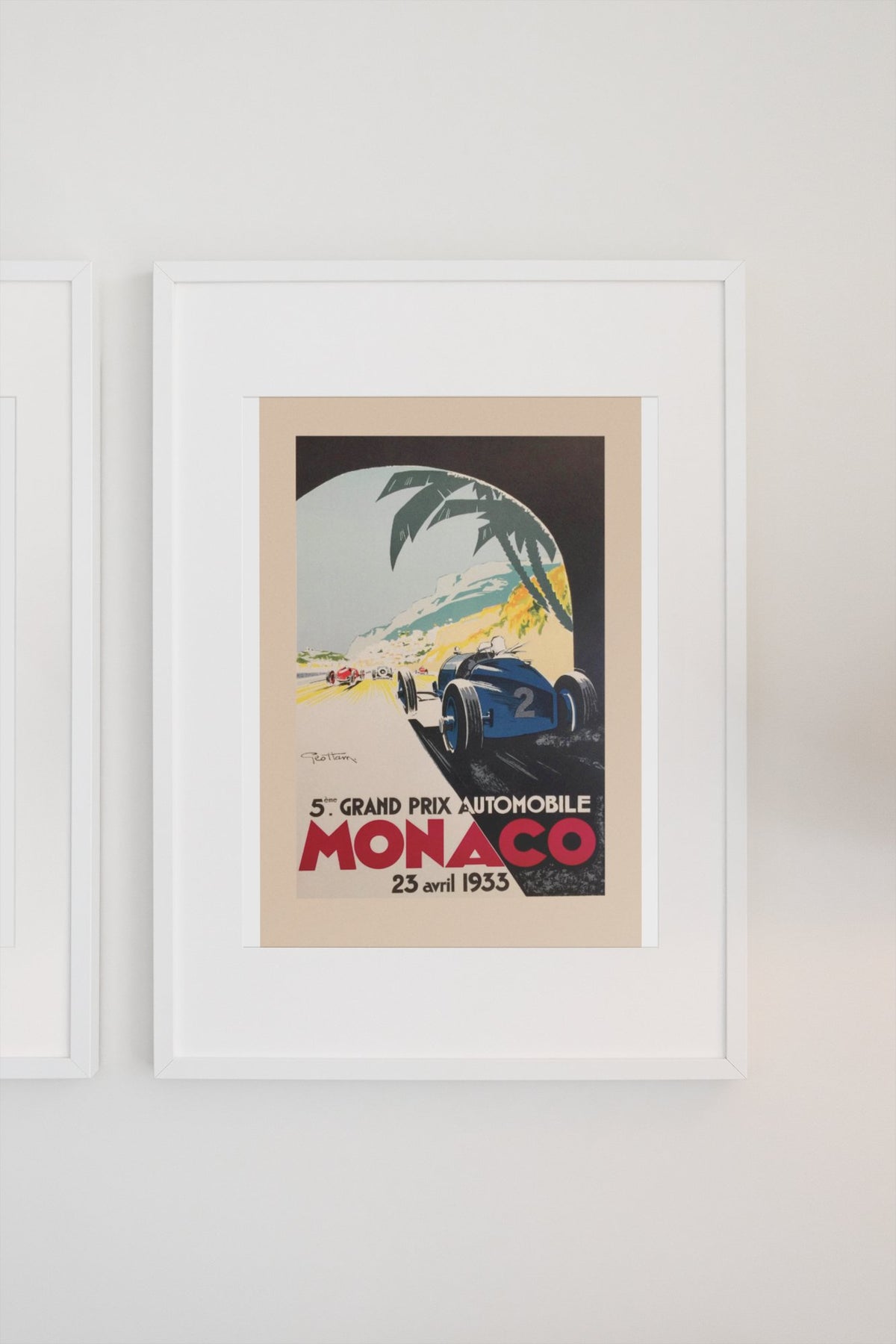 Monaco Grand Prix 1933 poster in a white frame on a light wall