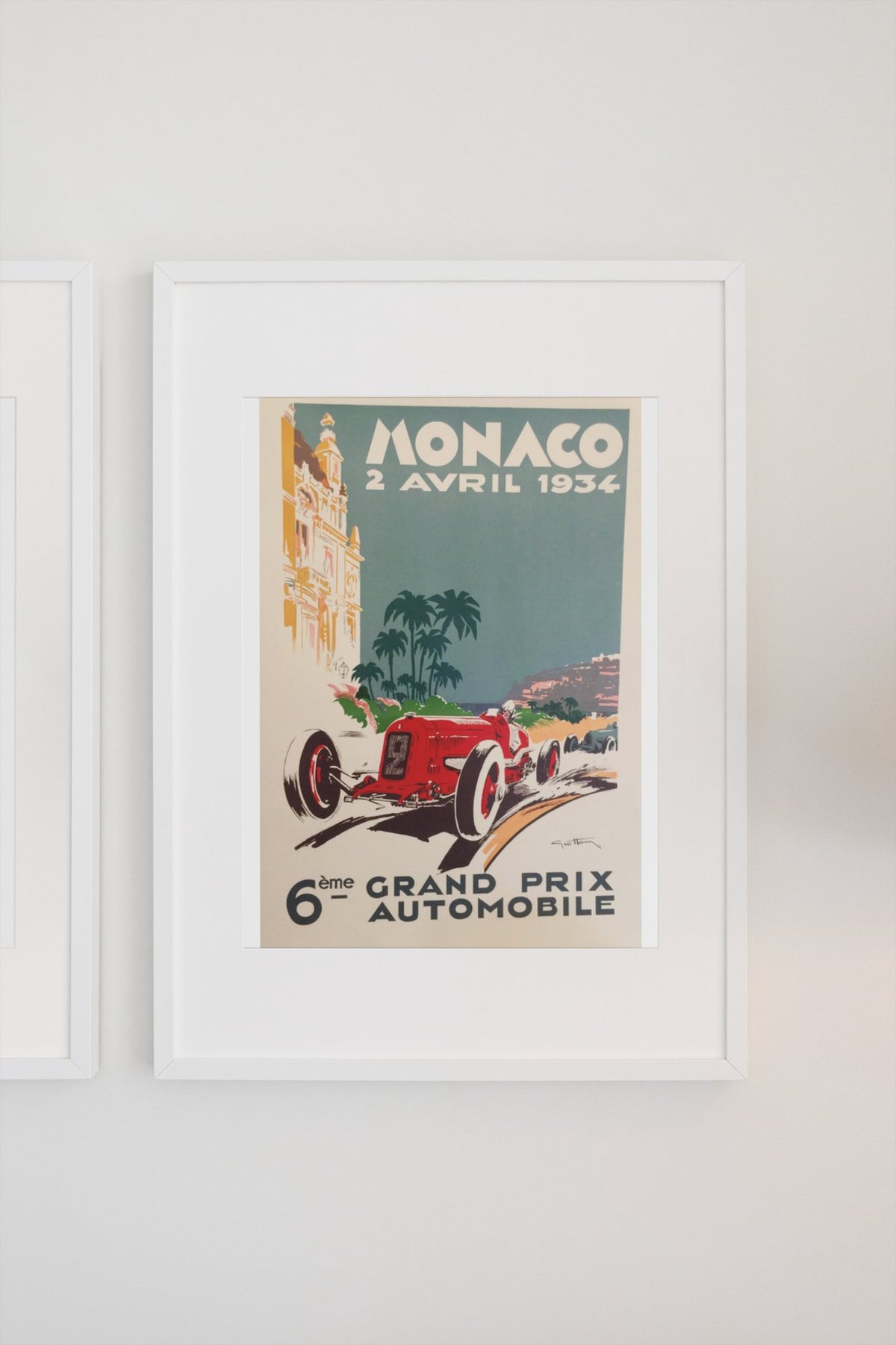 Monaco Grand Prix 1934 poster in a white frame on a light wall