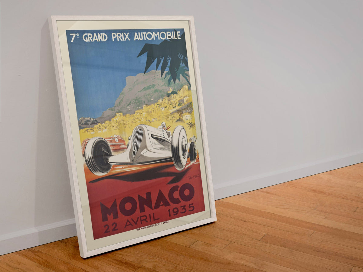 Monaco Grand Prix 1935 poster in a white frame leaning against a wall