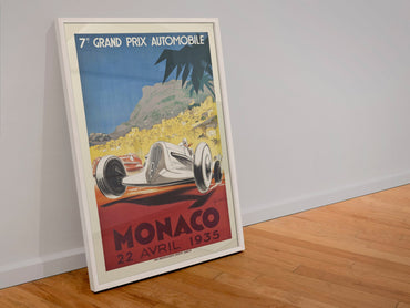 Monaco Grand Prix 1935 poster in a white frame leaning against a wall