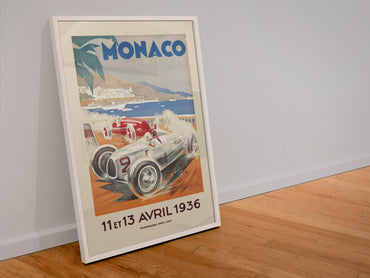 Monaco Grand Prix 1936 poster in a white frame leaning against a wall