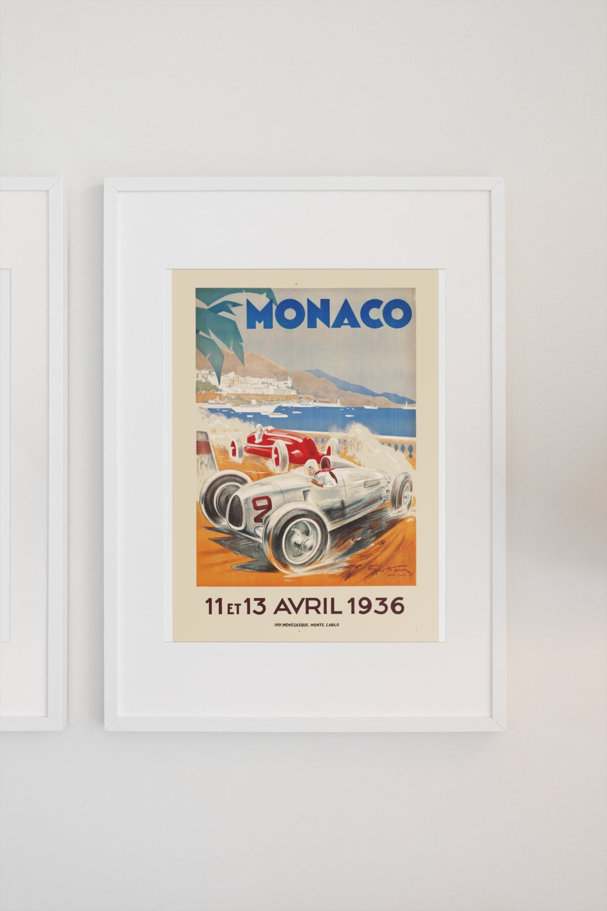 Monaco Grand Prix 1936 poster in a white frame on a light wall